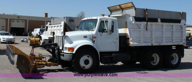 image for item A2891 1999 International 4900 tandem axle dump truck with plow and spreader