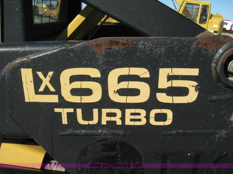 image for item A4473 1999 New Holland LX665 Turbo Super Boom skid loader