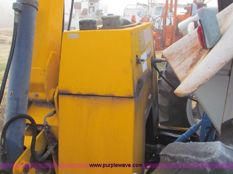 image for item B7018 1986 Ford 5900 tractor with flail boom mower