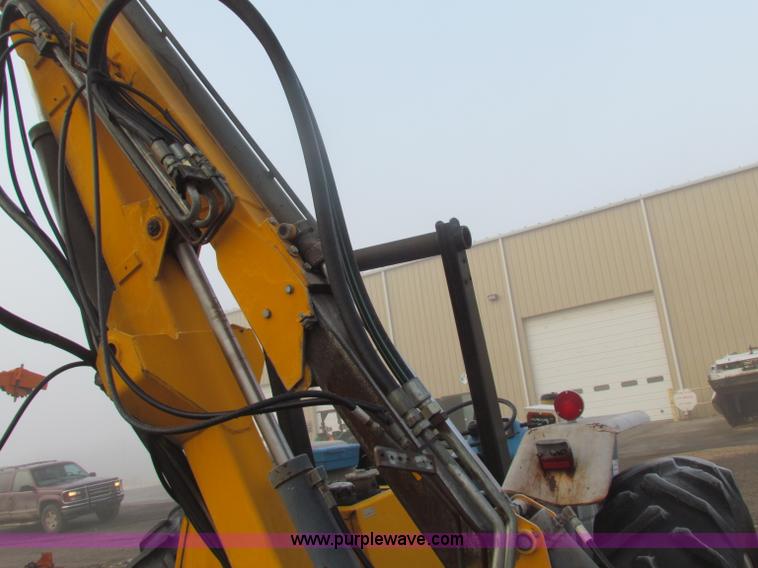 image for item B7018 1986 Ford 5900 tractor with flail boom mower