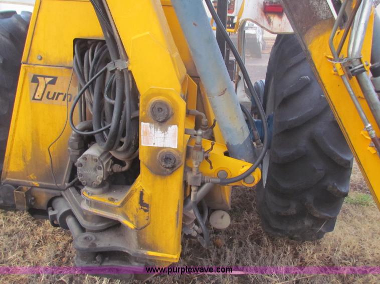 image for item B7018 1986 Ford 5900 tractor with flail boom mower