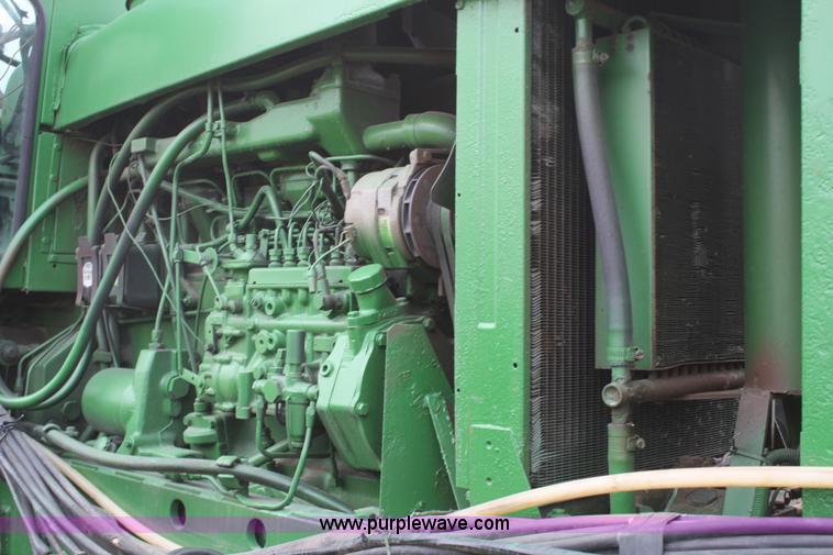 image for item A6560 John Deere 7520 shop built sprayer