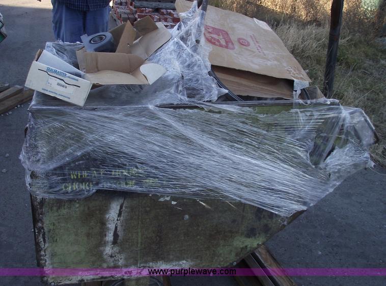 image for item E9569 Three wheel dump cart filled with assorted bearings and seals