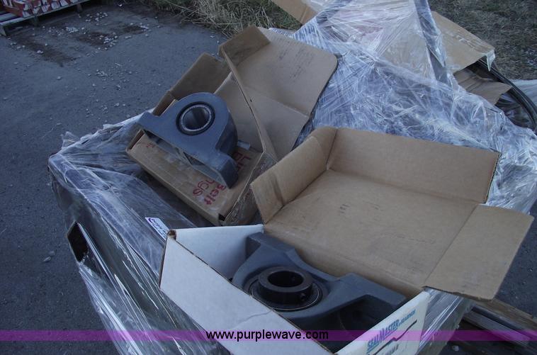 image for item E9569 Three wheel dump cart filled with assorted bearings and seals