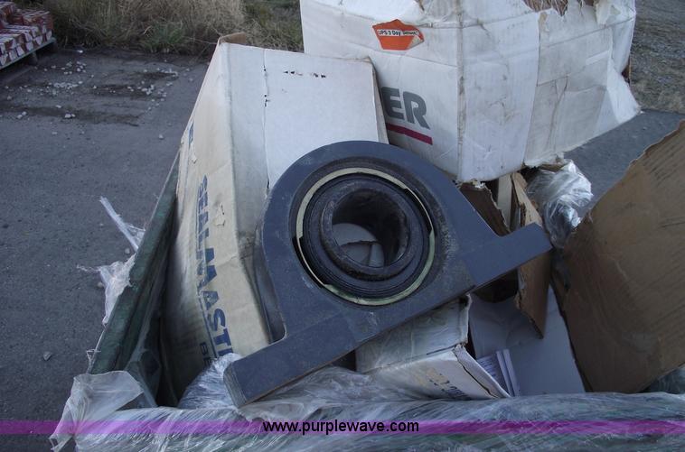 image for item E9570 Three wheel dump cart filled with assorted  bearings and seals