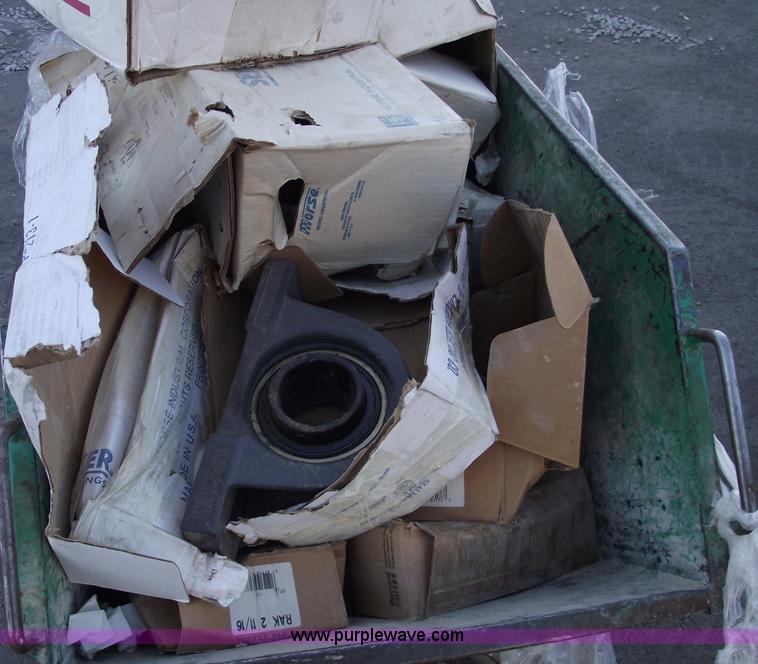 image for item E9570 Three wheel dump cart filled with assorted  bearings and seals