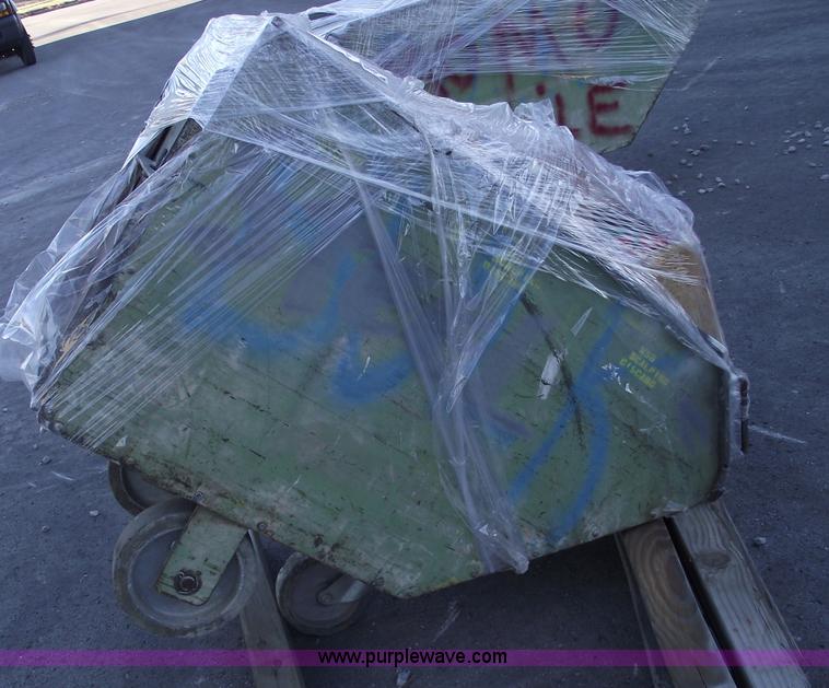 image for item E9571 Three wheel dump cart filled with assorted industrial electric parts