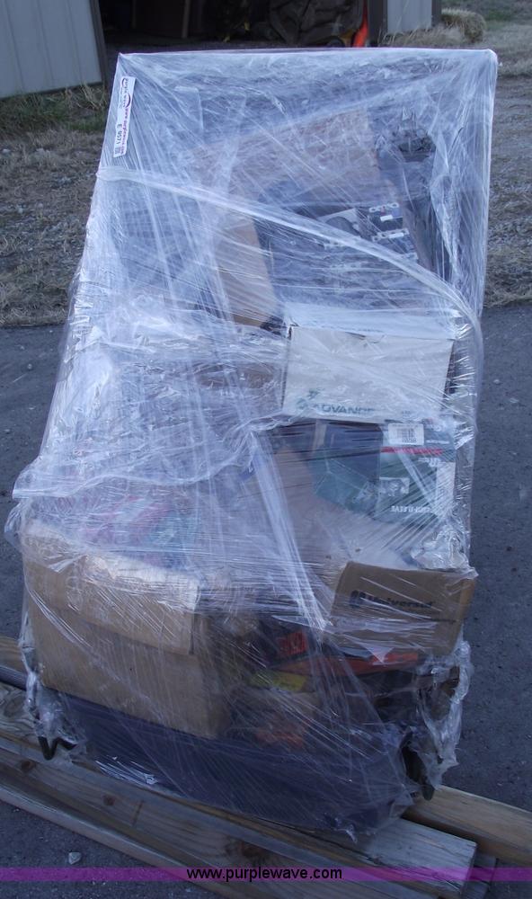 image for item E9571 Three wheel dump cart filled with assorted industrial electric parts