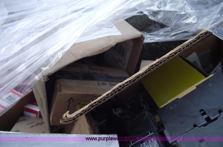 image for item E9571 Three wheel dump cart filled with assorted industrial electric parts