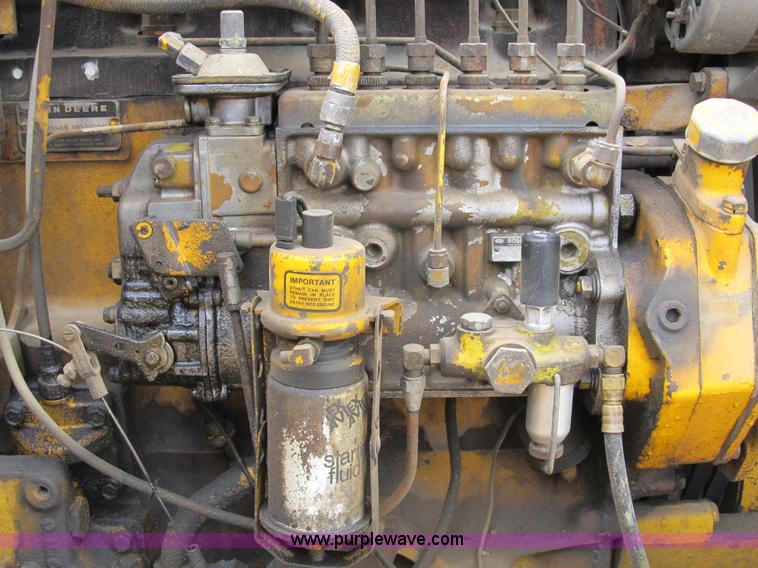 image for item B2697 1983 John Deere 762 paddle wheel scraper