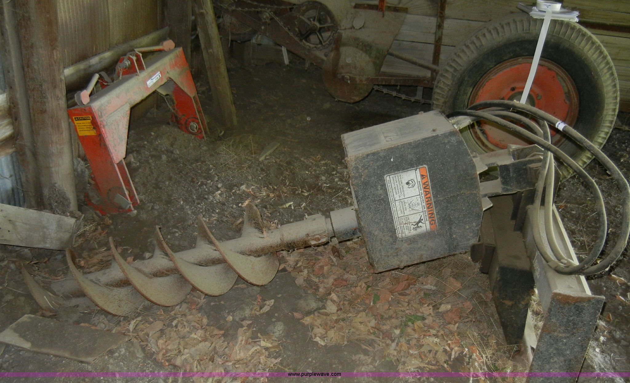 Lowe hydraulic post hole digger skid steer attachment in KS