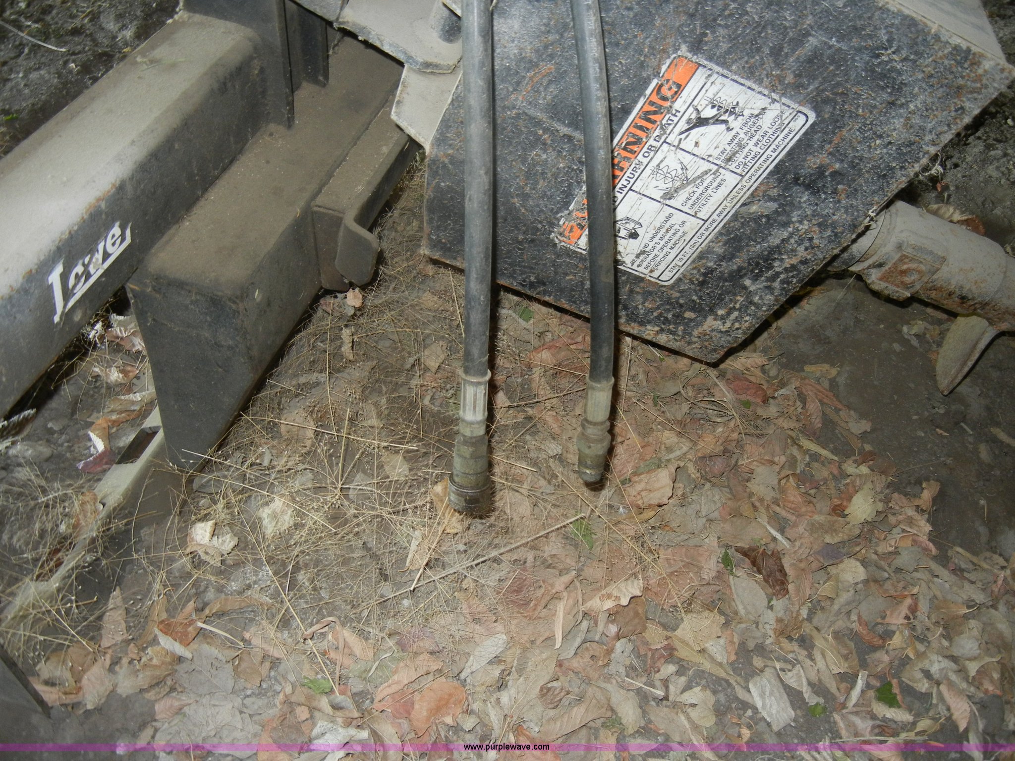 Lowe hydraulic post hole digger skid steer attachment in KS