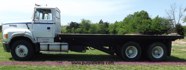 image for item C2024 1996 Ford LTA9000 AeroMax flatbed dump truck