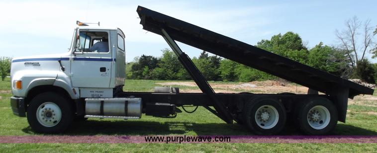 image for item C2024 1996 Ford LTA9000 AeroMax flatbed dump truck