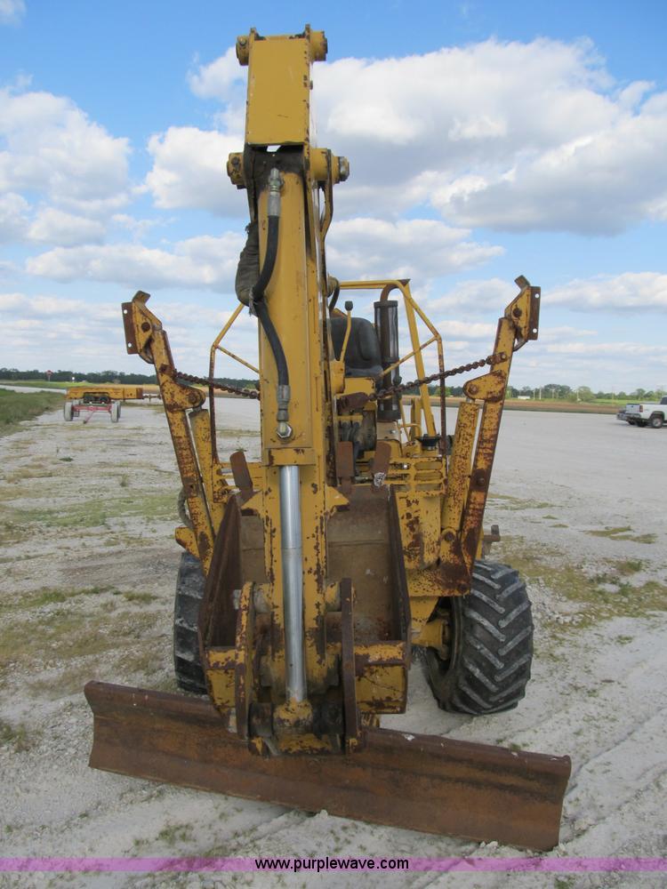 image for item B2702 1999 Vermeer V4750 trencher/backhoe combo with cable plow