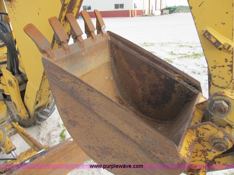 image for item B2702 1999 Vermeer V4750 trencher/backhoe combo with cable plow