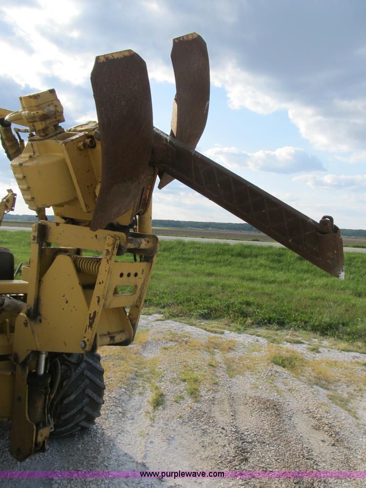 image for item B2702 1999 Vermeer V4750 trencher/backhoe combo with cable plow