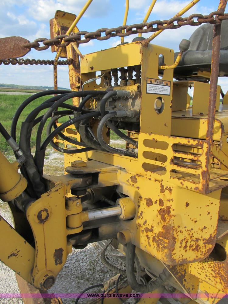 image for item B2702 1999 Vermeer V4750 trencher/backhoe combo with cable plow