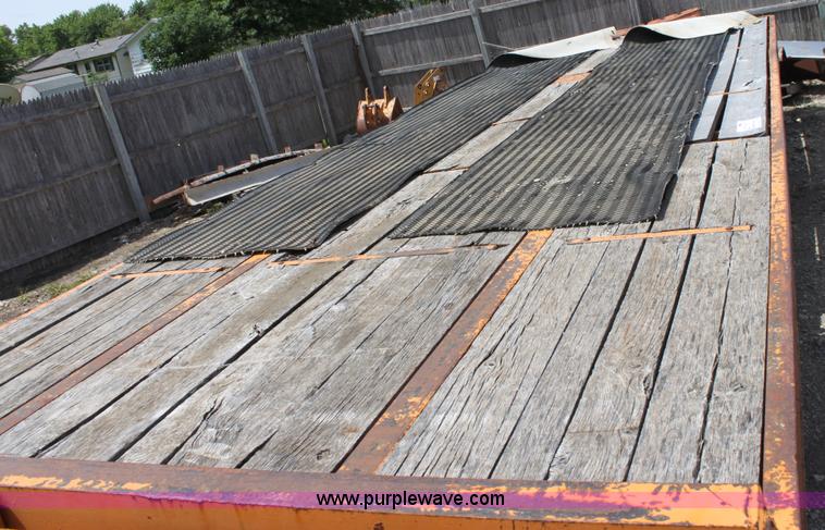 image for item D7995 2003 tandem axle tilt deck trailer