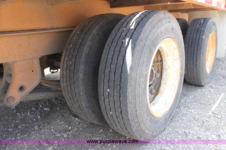 image for item D7995 2003 tandem axle tilt deck trailer