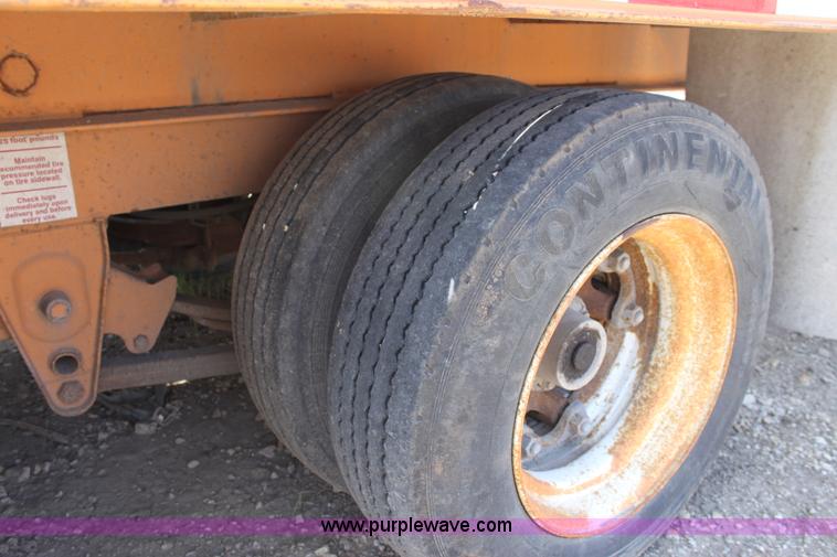 image for item D7995 2003 tandem axle tilt deck trailer