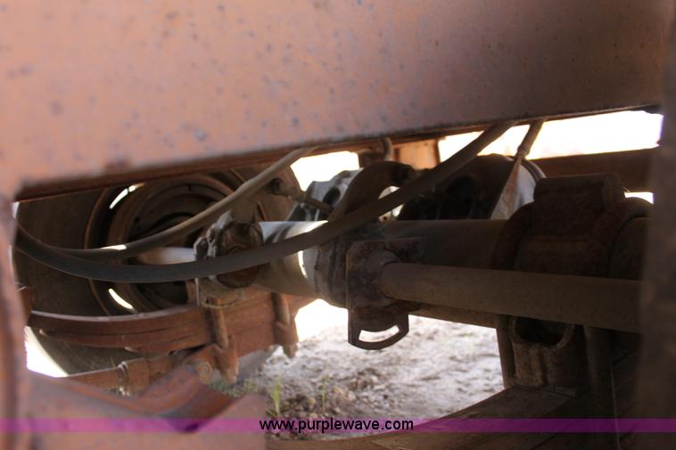 image for item D7995 2003 tandem axle tilt deck trailer