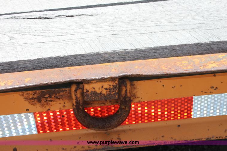 image for item D7995 2003 tandem axle tilt deck trailer