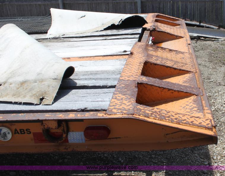 image for item D7995 2003 tandem axle tilt deck trailer