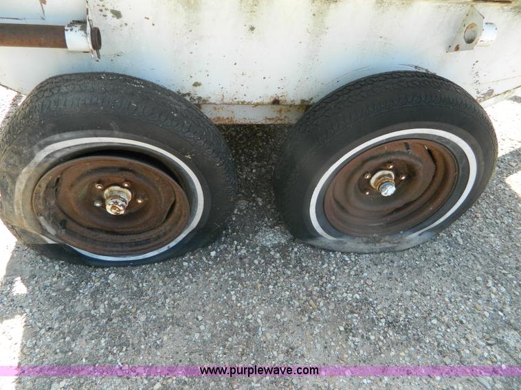 image for item M9780 Portable water tank on four wheel trailer