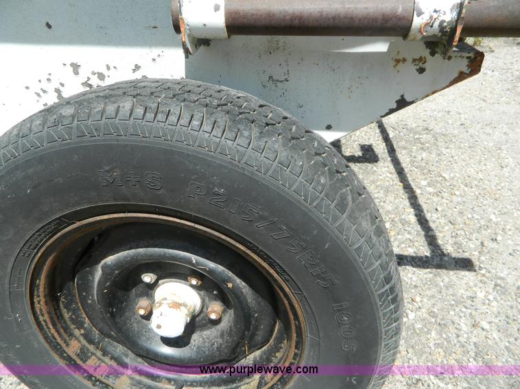 image for item M9780 Portable water tank on four wheel trailer