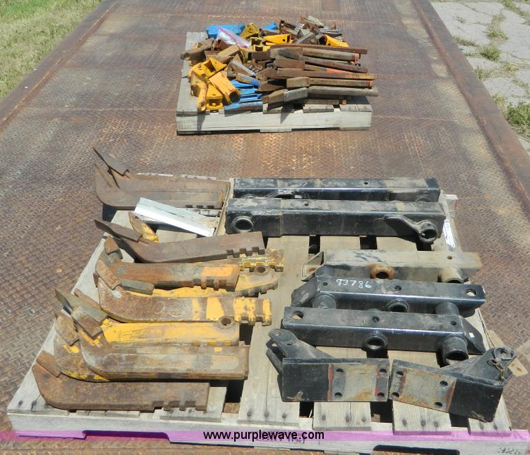 image for item T9916 Assortment of ripper teeth, hardware, and hard-faced rock teeth