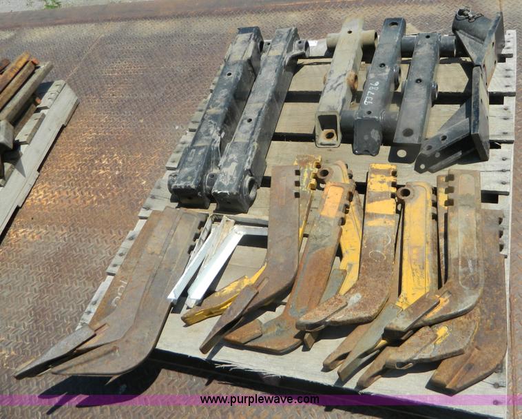 image for item T9916 Assortment of ripper teeth, hardware, and hard-faced rock teeth