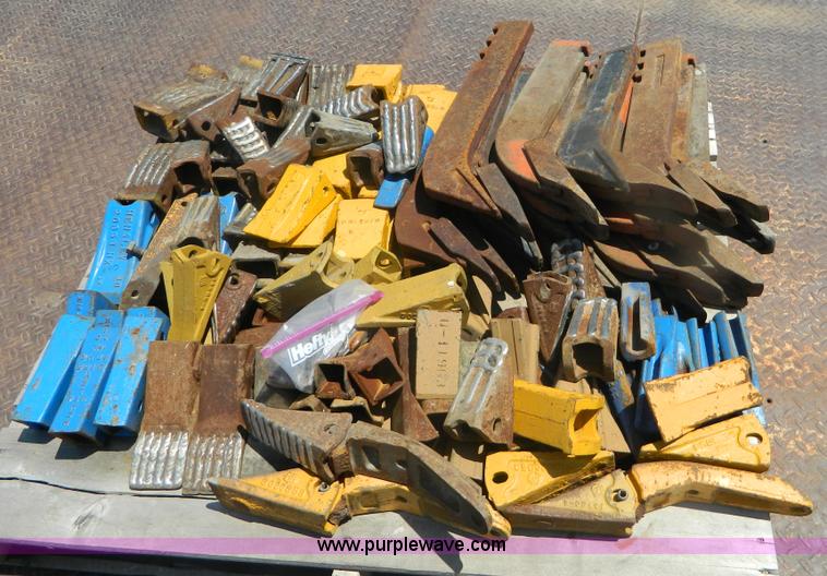 image for item T9916 Assortment of ripper teeth, hardware, and hard-faced rock teeth