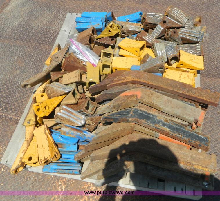 image for item T9916 Assortment of ripper teeth, hardware, and hard-faced rock teeth