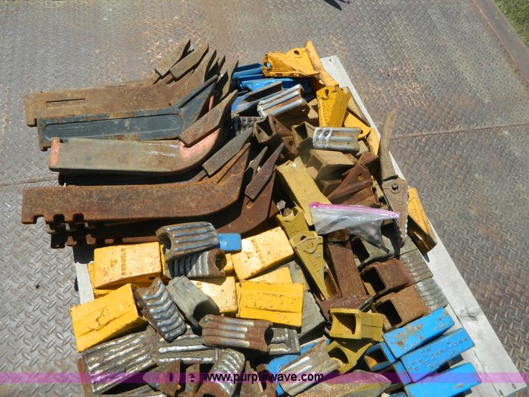 image for item T9916 Assortment of ripper teeth, hardware, and hard-faced rock teeth