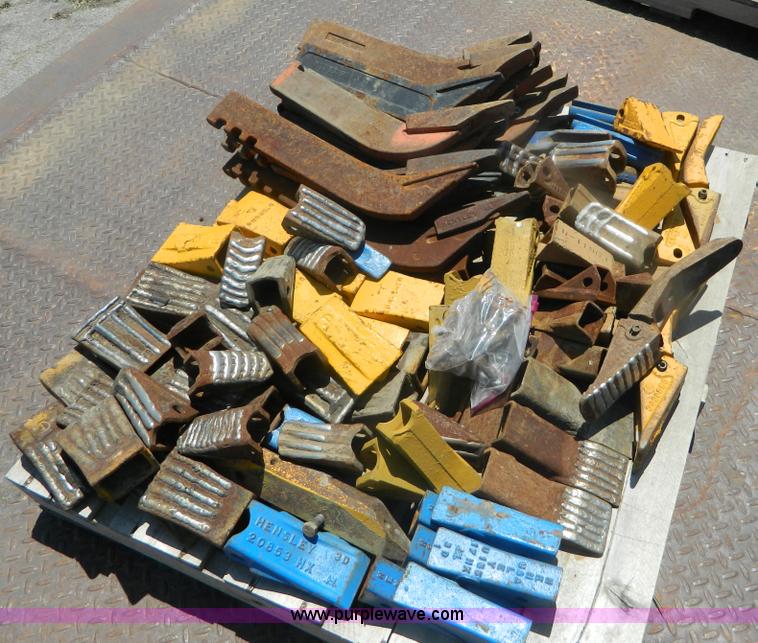 image for item T9916 Assortment of ripper teeth, hardware, and hard-faced rock teeth