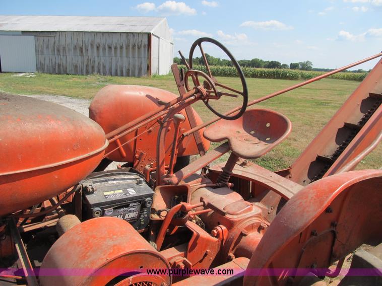 image for item B2765 1950 Allis-Chalmers WD tractor with mounted corn picker