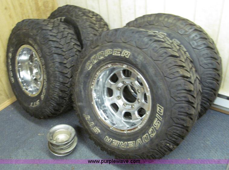 image for item E2002 (4) aluminum wheels and mud tires