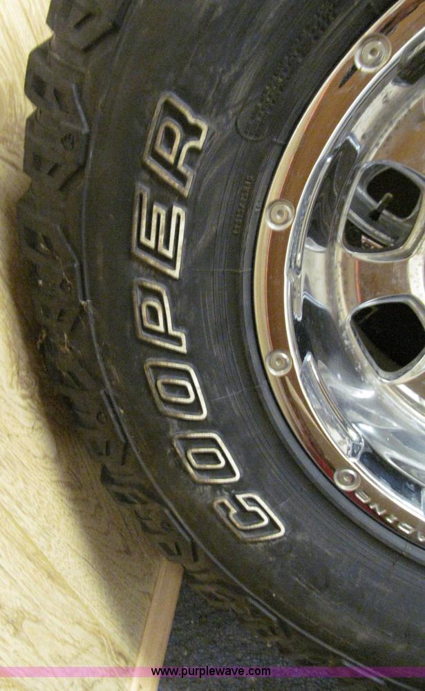 image for item E2002 (4) aluminum wheels and mud tires