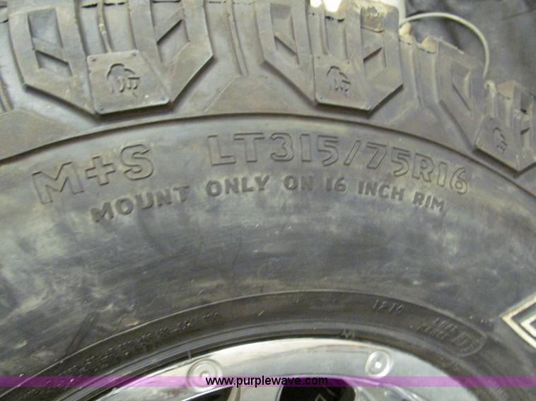 image for item E2002 (4) aluminum wheels and mud tires
