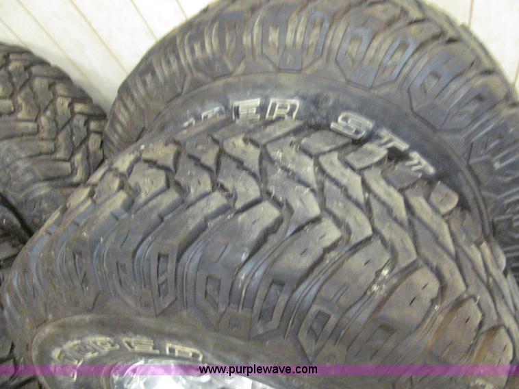 image for item E2002 (4) aluminum wheels and mud tires