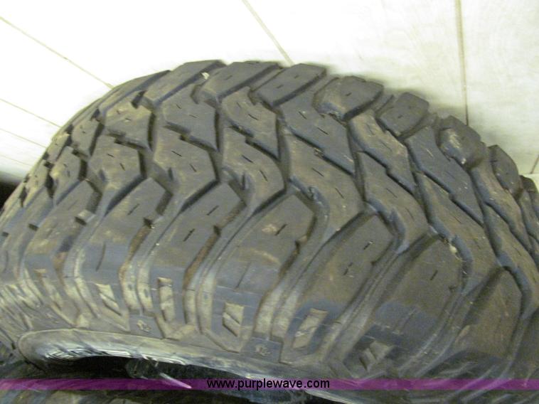 image for item E2002 (4) aluminum wheels and mud tires
