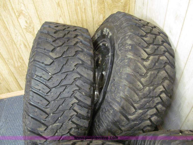 image for item E2002 (4) aluminum wheels and mud tires