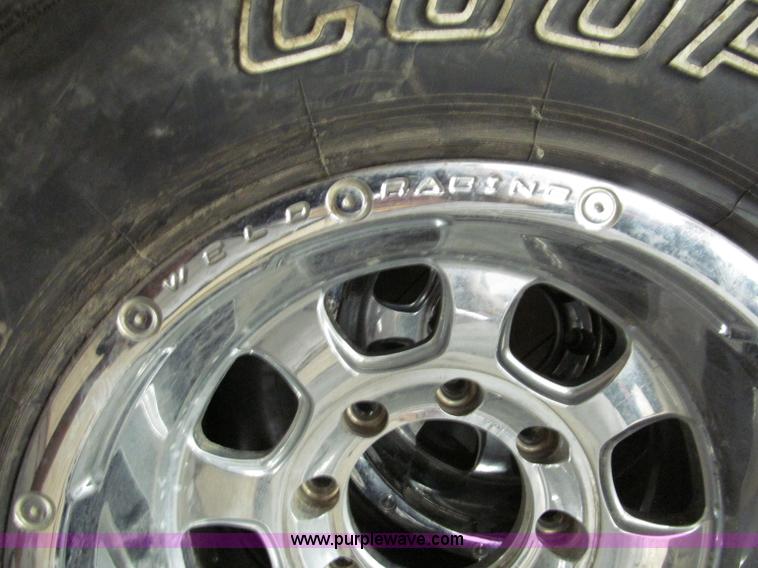 image for item E2002 (4) aluminum wheels and mud tires