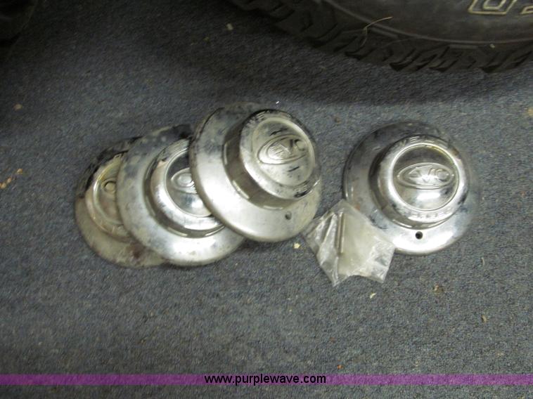 image for item E2002 (4) aluminum wheels and mud tires