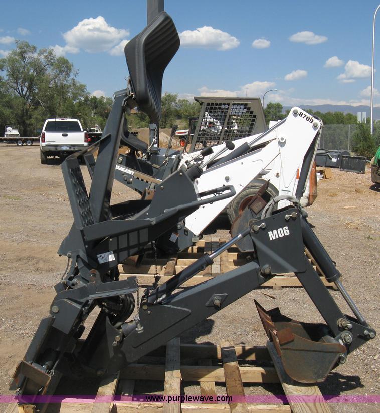 Bobcat M06 backhoe skid steer attachment in Colorado Springs, CO Item B8090 sold Purple Wave