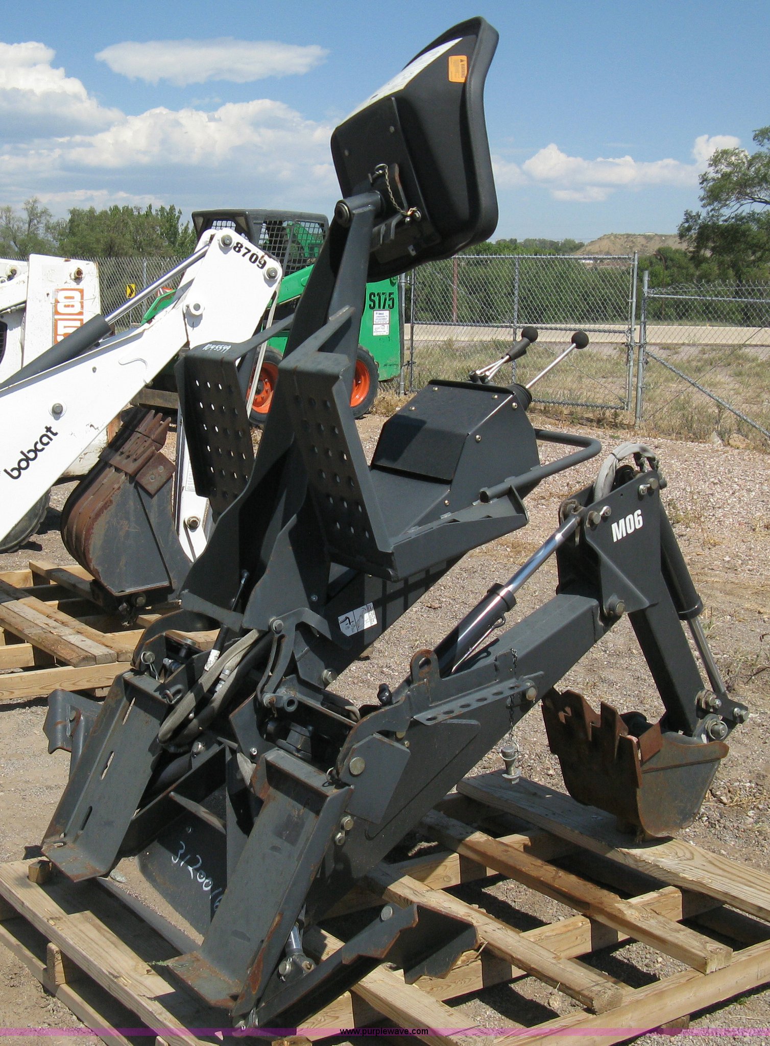 Bobcat M06 backhoe skid steer attachment in Colorado Springs, CO Item B8090 sold Purple Wave