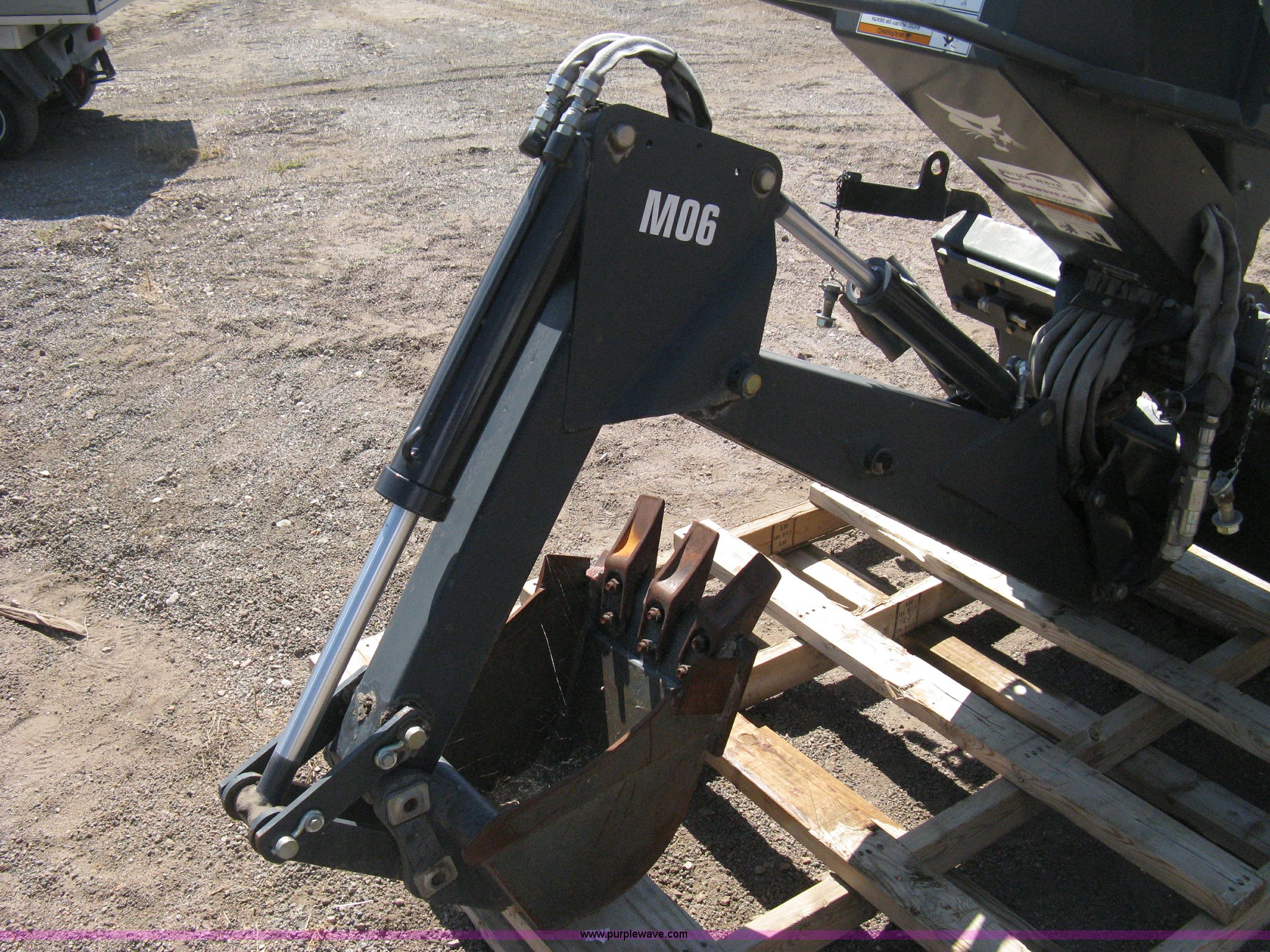Bobcat M06 backhoe skid steer attachment in Colorado Springs, CO Item B8090 sold Purple Wave