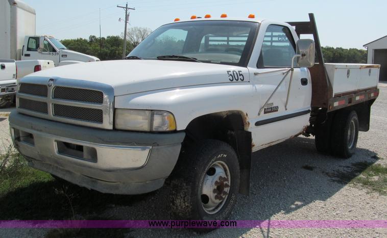 image for item E2102 1998 Dodge Ram 3500 Laramie SLT flatbed pickup truck