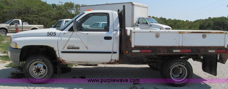 image for item E2102 1998 Dodge Ram 3500 Laramie SLT flatbed pickup truck